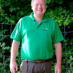 Thomas Schwab halbe Figur im grünen Polohemd, lacht
